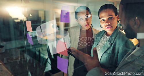 Image of Business woman, tablet and notes on board in an office for training, meeting or ideas. Men and women talking about strategy, planning or scrum for pitch with technology, leader and a team at night