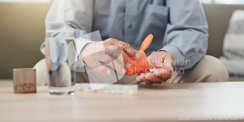 Image of Hands, elderly person and pills on table with water, medicine for health and treatment for sick patient at home. Pharmaceutical drugs, supplements or antibiotics with daily routine for healthcare