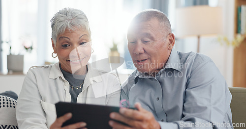 Image of Senior, couple and tablet on sofa for online streaming, reading ebook or planning for retirement at home. Elderly people with digital technology for internet, happy with online choice and discussion