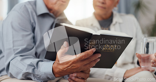 Image of Couple, hands and home for reading bible, talking of faith and God with helping, support and scripture on sofa. Mature people or pastor in living room with holy book for religion and Christianity