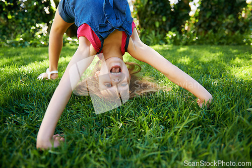 Image of Child, back and bend or bridge or outdoor play in summer or flexibility game or practice, fun or backyard. Kid, face and excited or gymnastics stretching on grass lawn in London park, happy or garden
