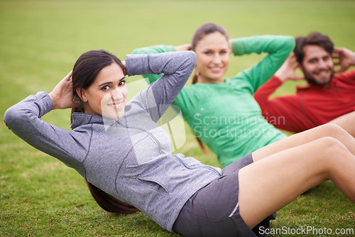 Image of Friends, sit ups and exercise on field for portrait, training or happy for stomach fitness in summer. People, man and women with wellness with smile, core workout and group on grass lawn in Australia