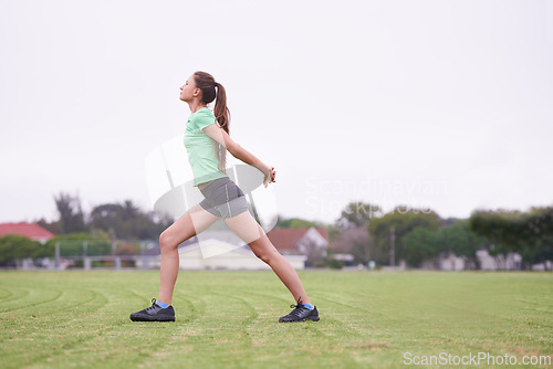 Image of Sports, stretching and woman on field for exercise, workout and training for running outdoors. Fitness, park and person warm up for wellness, healthy body and exercising for performance and balance