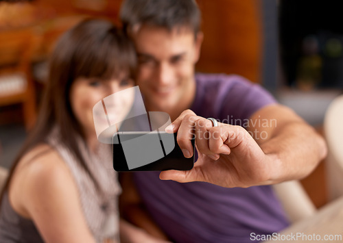 Image of Love, smile and couple with selfie blur in house for bonding, photography or memory with care. Smartphone, profile picture or people embrace with romance at home for social media, blog or vlog update