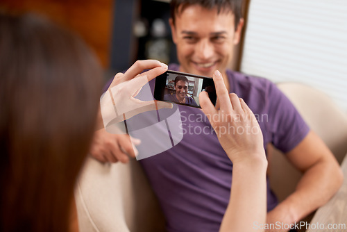 Image of Photography, phone screen and couple in house happy, bonding and having fun together. Smartphone, profile picture and woman with photo, app or romantic memory of husband while chilling in living room