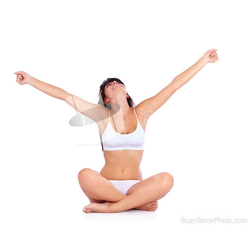 Image of Woman, freedom and fitness in studio for success, winning or excited on floor with workout results or training. Young person looking up and celebration for wellness and exercise on a white background