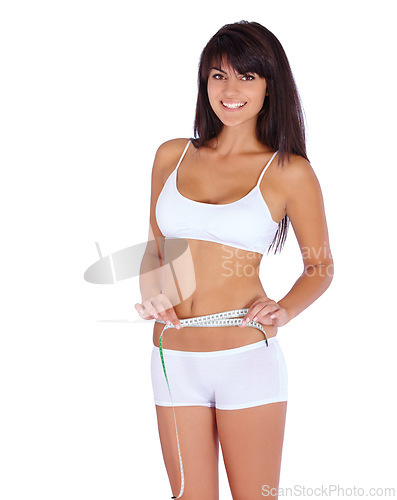 Image of Woman, body and measure tape in studio for fitness, health and weight loss results of training progress. Portrait of model or person check stomach for exercise or workout goals on a white background