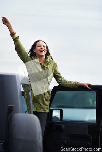 Image of Happy woman, road trip and freedom with car for travel, drive or final stop at destination. Excited young female person with smile in satisfaction and leaning on vehicle door for outdoor adventure