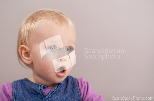 Image of Children, wow and baby in studio with surprise, announcement or open mouth on grey background. Kids, mockup and girl face shocked by learning promo, news or child development, information or space