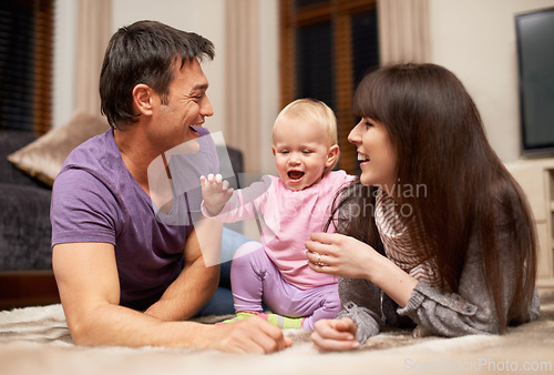Image of Love, baby and parents on a floor happy, laughing or playing while bonding in their home together, Family, support and excited kid with people in living room for child development, learning or games