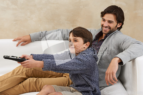 Image of Remote, TV and father and child on sofa together for bonding, relationship and relax in living room. Family, parents and dad with young son for cartoon, watching movies and entertainment in home