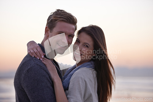 Image of Sunset, hug and portrait of happy couple on beach for tropical holiday adventure, love and bonding together. Evening, happy man and woman on romantic date with ocean, sky and embrace on vacation.