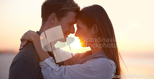 Image of Couple, forehead touch on beach and sunset, nature and travel with bonding for love and commitment outdoor. People with support, trust and hug with adventure together for honeymoon or anniversary