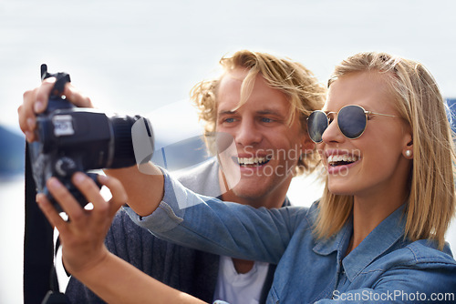 Image of Happy couple, camera and selfie in photography for travel, memory or outdoor moment together in nature. Face of young man and woman with smile for photo, picture or capture on adventure or journey