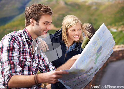 Image of Happy couple, map and travel with location, destination or coordinates on mountain in nature. Young man and woman with smile, document or paper with routes for navigation, help or outdoor tourism