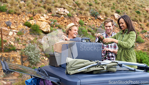 Image of Friends, group and luggage on car roof for road trip together or camping holiday as explore, mountain or vacation. Men, woman and unloading bags on vehicle in Italy or travel, journey or suitcase