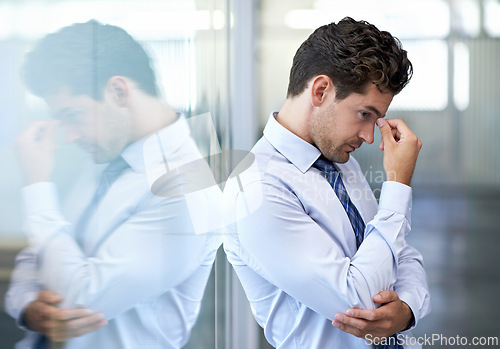 Image of Headache, stress and business man with burnout, tired or anxiety for financial crisis in office. Frustrated, depression and serious professional with fatigue, thinking or fail with regret for mistake