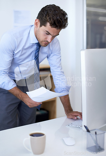Image of Businessman, computer and paperwork in office for online research for feedback review, planning or brainstorming. Male person, document and financial consultant for budget, accounting or investing