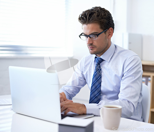 Image of Businessman, laptop and typing in office for online communication as financial consultant, email or internet. Male person, glasses and corporate company in New York for accounting, loan or investment