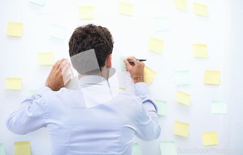 Image of Businessman, writing and sticky notes in office for strategy, brainstorming and project planning with rear view. Entrepreneur, employee and ideas for agenda, schedule and proposal information at work