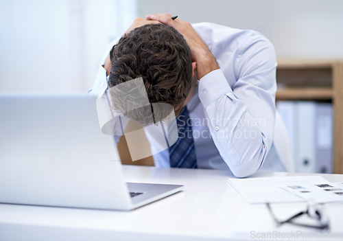 Image of Businessman, office and laptop with desk, stressed and frustrated with mistake or failure. Person, technology and headache with debt, report or burnout for corporate mental health or depression