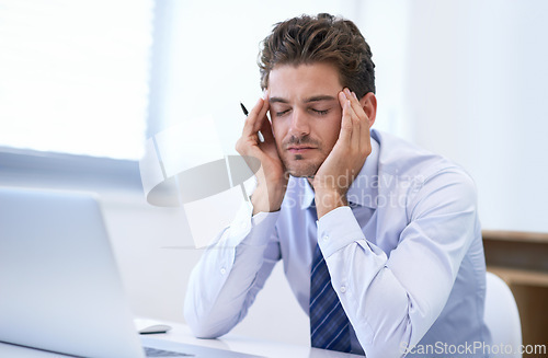 Image of Headache, pain and business man with stress, fatigue and anxiety for overwork in office. Migraine, depression and professional massage temples for burnout, sick and tired agent frustrated by laptop