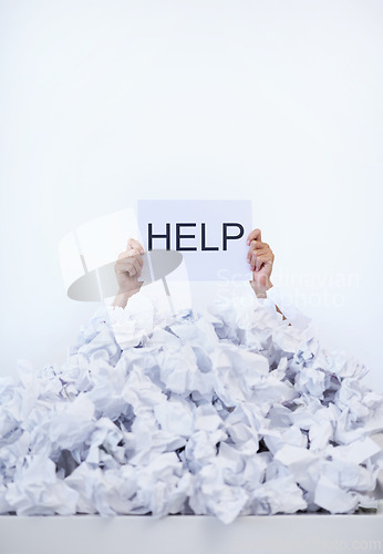 Image of Person, desk and hands with pile of paperwork, sign and help with burnout, stress and administration. Debt, bills and worker lost in documents, overworked and overwhelmed with pressure in office.
