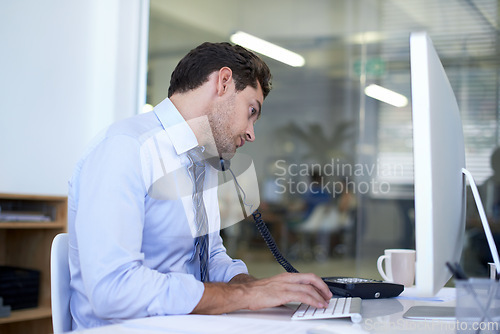 Image of Businessman, phone call and computer for discussion as financial consultant for client loan, investment or accounting. Male person, telephone and typing in New York office, planning or networking
