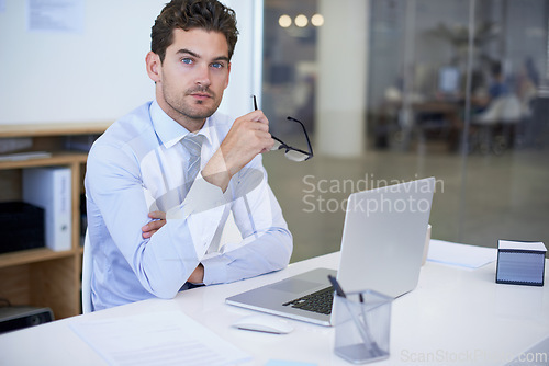 Image of Businessman, portrait and laptop office with confidence at desk as financial advisor, planning or investing. Male person, glasses and face in New York or corporate employee, accounting or research