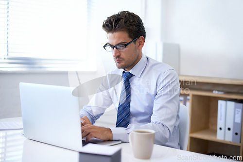 Image of Businessman, laptop and typing in online email or communication as financial consultant, research or internet. Male person, glasses and corporate company in New York or accounting, loan or investment