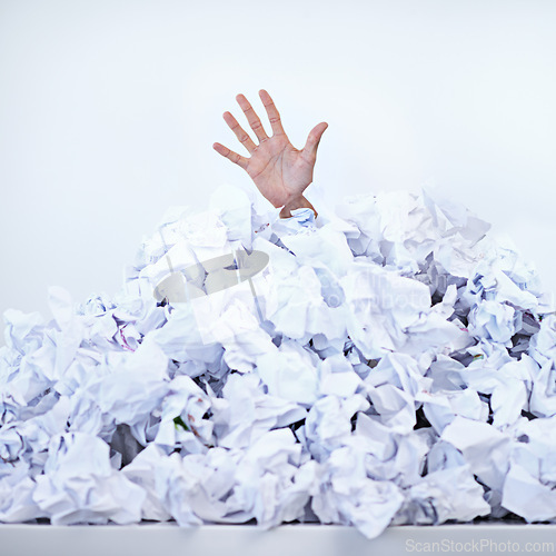 Image of Person, business and hand or paper pile as corporate deadline or buried in documents for work stress, problem or responsibilities. Fingers, trapped and employee reach for help, burnout or overwhelmed