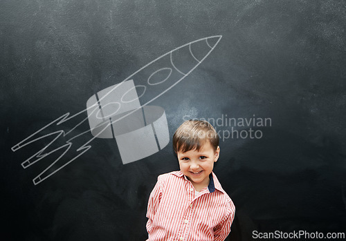 Image of Child, boy and portrait or happy by blackboard with drawing, missile and creative fun in classroom at school. Kid, student and smile for illustration, education or chalkboard with mockup at preschool