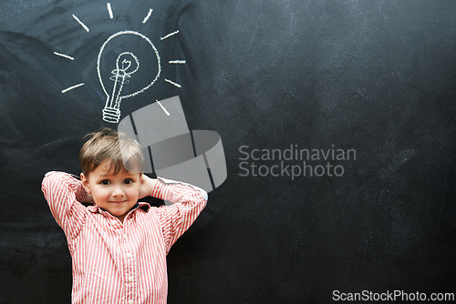 Image of Student, child and chalkboard with lightbulb for solution, learning and creative ideas in school on mockup space. Portrait of a kid, learner or boy with light bulb, emoji and blackboard for knowledge