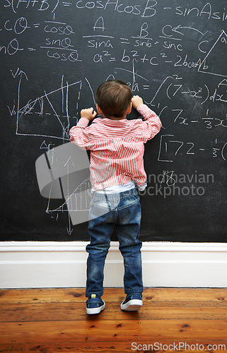 Image of Math, blackboard and child writing in school for learning, development and young boy genius in classroom. Kid, numbers and formula on chalkboard with knowledge for education, growth and solution