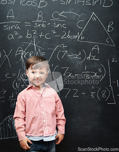 Image of Smart, kid and math on chalkboard for school, learning and education with happy portrait and confidence. Genius and clever child, boy or student with equation, numbers and test for IQ or intelligence