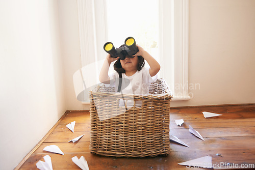 Image of Binoculars, paper plane and child playing with adventure, imagination and fun in basket at home. Fantasy, little pilot and playful boy in box with future dream, growth and development with airplane