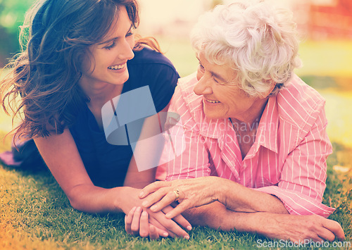 Image of Smile, senior mother and woman holding hands on grass outdoor to relax, support and bonding together. Park, elderly person and adult daughter in garden for connection, relationship and love of family