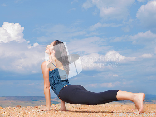 Image of Woman, yoga and stretching on mountain or peace as wellness zen or outdoor nature, pilates or blue sky. Female person, relax and countryside in America or mindfulness practice, balance or performance