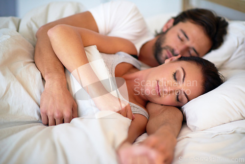 Image of Couple, dreaming and rest in bedroom of home, peace and man together with woman in bed. Marriage, love and partners hugging for romance with care, relax and pyjamas for sleeping in house and embrace