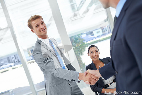Image of Shaking hands, partnership and business men in office for agreement, deal or collaboration. Smile, meeting and professional people with handshake for onboarding or hiring welcome in workplace.