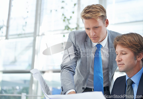 Image of Men, reading and paperwork for collaboration, meeting and teamwork in boardroom of modern office. Documents, male employees and corporate workers in discussion for review, planning and presentation