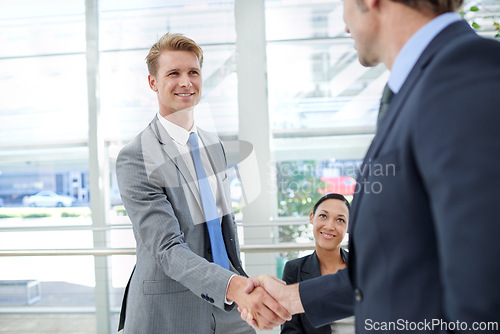 Image of Shaking hands, meeting and business men in office for agreement, partnership or collaboration. Smile, deal and professional male people with handshake for onboarding or hiring welcome in workplace.