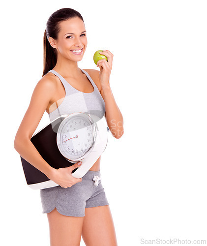 Image of Scale, apple and portrait of woman in studio with snack for weight loss, health and wellness diet. Fitness, vitamins and female person eating organic, fresh and nutrition fruit by white background.