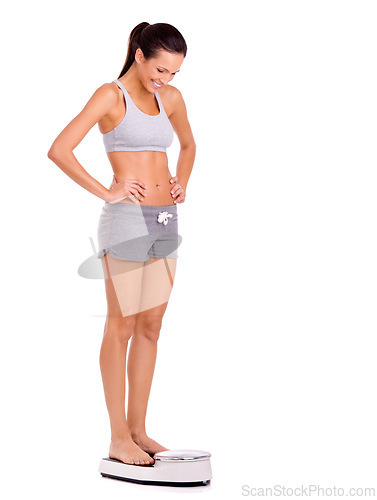 Image of Finally. Scale, happy and woman in studio for weight loss, health and wellness diet victory or success. Smile, fitness and person measuring body for exercise, workout or training by white background.