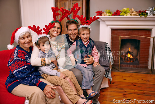 Image of Christmas, portrait and happy big family on sofa in home for holiday or festive celebration. Xmas, parents and smile of children with grandmother in living room, antlers or bonding together at party