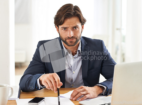 Image of Desk, laptop and portrait of businessman with anger, paperwork and serious financial analyst in office. Consultant, business advisor or frustrated man with computer, documents and notes at startup.