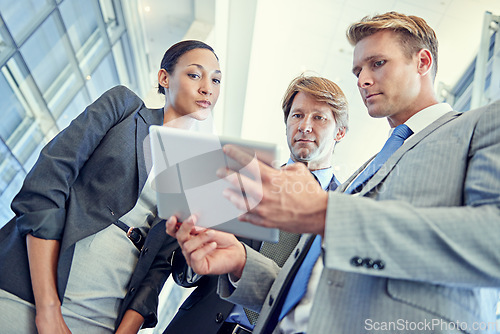 Image of Business people, tablet and discussion for project in office, collaboration and unity for proposal. Coworkers, workplace and teamwork for reading a report, support and online for plan and networking