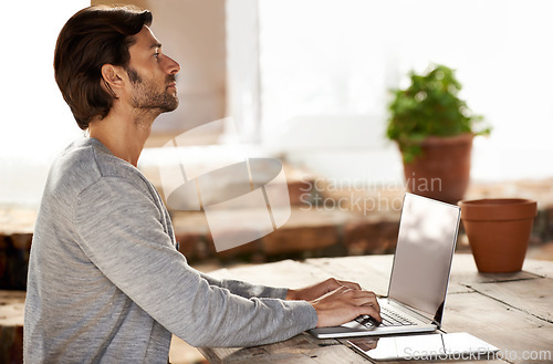 Image of Businessman, laptop and typing or research in cafe with remote work, copywriting or freelance employee. Entrepreneur, person and technology for email, writing and online planning in coffee shop