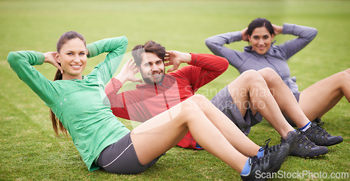 Image of Friends, sit ups and fitness on field for portrait, training or happy for abdomen exercise in summer. People, man and women with wellness with smile, core workout and group on grass lawn in Australia