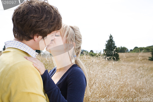 Image of Young caucasian couple kissing